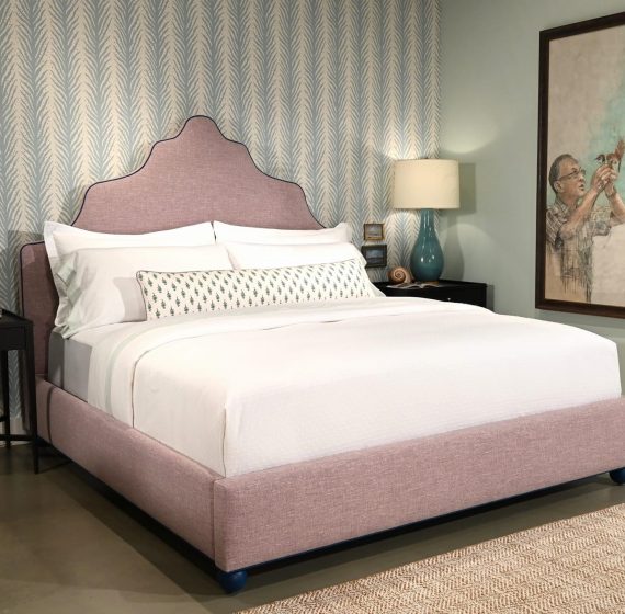 A white bed in a bedroom, possibly with matching white furniture or contrasting bedding for a clean, modern look.